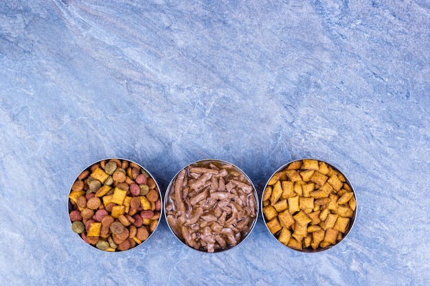 An organized display of various dry cat food kibble shapes and sizes, highlighting the different textures and ingredients.