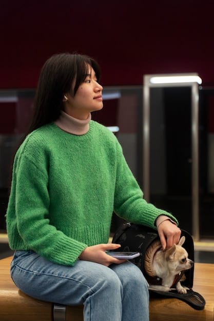 A woman interacts with her dog through a pet camera at home, which has a futuristic design and an advanced interface.