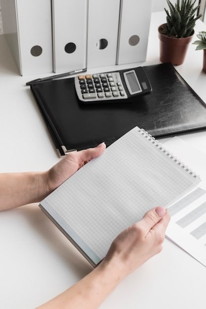 A close-up shot of a hand using a calculator, with financial documents and tax forms neatly organized on a desk, symbolizing meticulous financial management and tax planning.