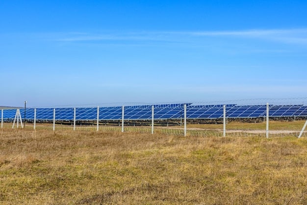 A solar panel farm in a rural area, with rows of solar panels stretching into the distance under a clear blue sky. The image emphasizes the scale and potential of renewable energy.