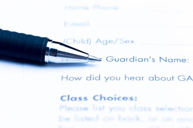 A close-up shot of the FAFSA application form, with a pen hovering over the section about dependency status. The image emphasizes the importance of understanding this aspect of the application.