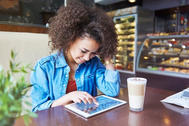 A person using a language learning app on their tablet while sitting in a coffee shop.