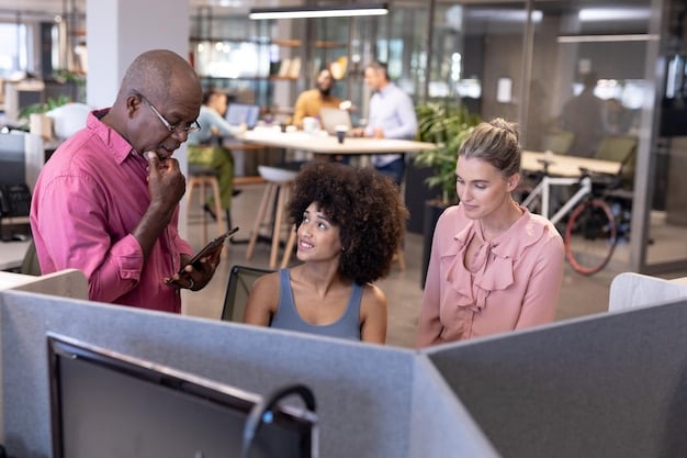 A diverse group of small business employees collaboratively working in a modern office space, highlighting inclusivity and proper workplace conditions.