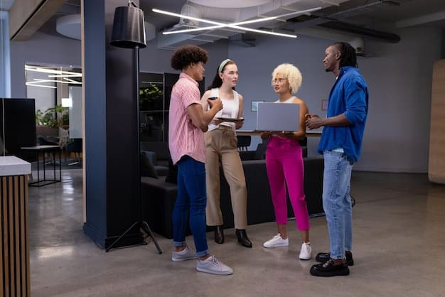 A diverse group of people working together in a modern, open-plan office. The scene showcases collaboration and teamwork, with employees using laptops and engaging in discussions. The atmosphere is vibrant and inclusive, highlighting the importance of human capital in the face of automation. The setting of the image reflects the theme of Labor Shortage Crisis: Will Automation Be the Answer by 2026? by emphasizing the need to address the skills gap via investment in reskilling and upskilling for existing employees.