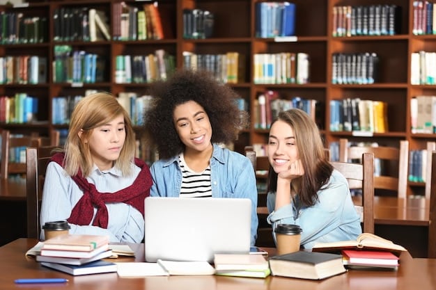 A diverse group of high school students studying together in a library, surrounded by books and laptops, indicating collaborative learning and AP exam preparation.