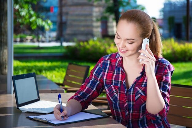 A student on the phone, taking notes during a call with a college admissions counselor, emphasizing the importance of direct communication and personalized guidance.