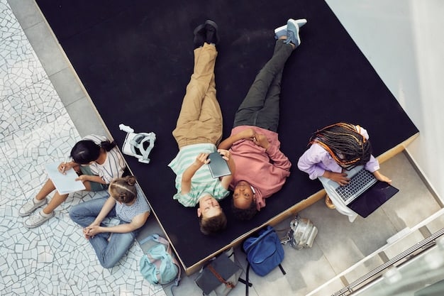 A high-angle shot of a diverse group of college students, dressed in casual clothes, relaxing on the campus lawn. Some are sitting on blankets, studying together, while others are playing frisbee in the background. The sun is shining, and lush green trees surround the students, suggesting a vibrant campus community. College Rankings Demystified: What You Need to Know Before Choosing a School can make this community seem perfect.
