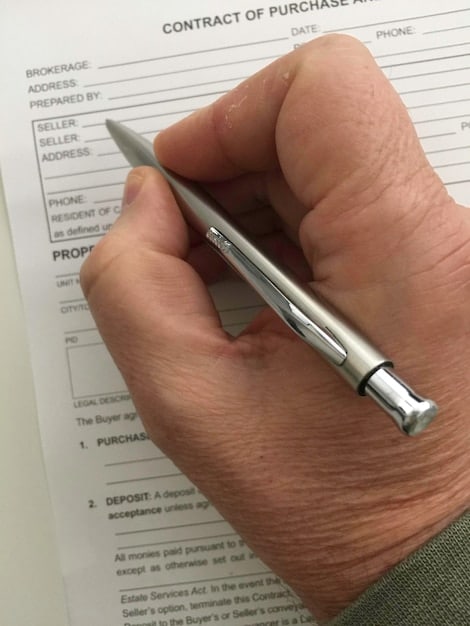 Close-up of a customs declaration form being carefully filled out with a pen, emphasizing the importance of accuracy in documentation. The image relates to Minimize Risk: Understanding and Avoiding Common US Customs Penalties and Fines by highlighting the need for careful attention to detail.